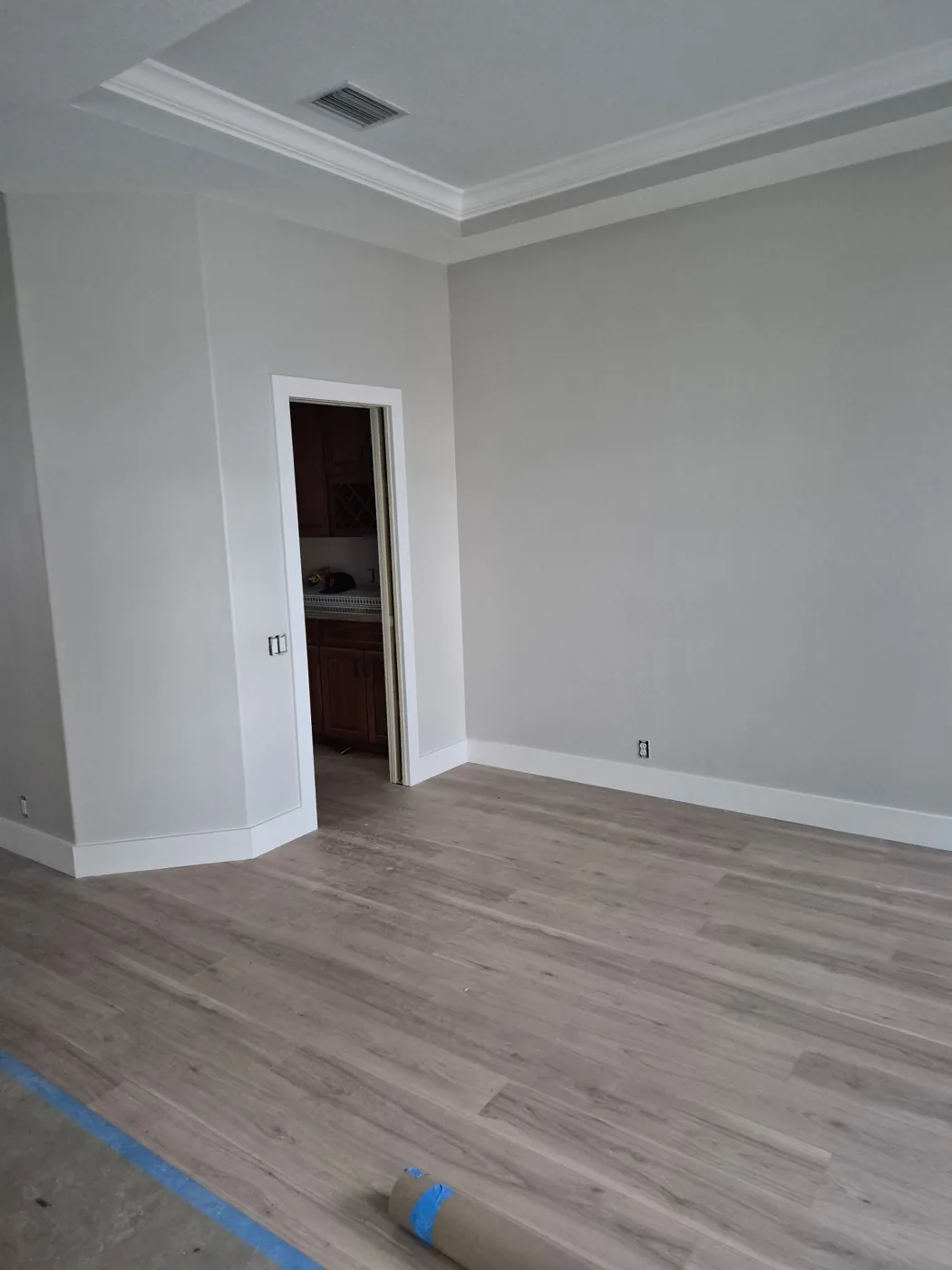 Refinished interior walls, white moldings and new wood-look flooring during the home update